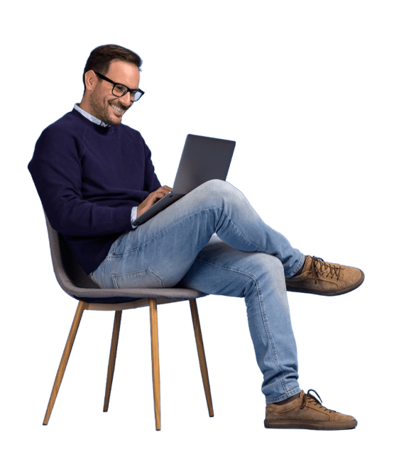 man sitting on chair with laptop smiling